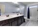 Bathroom with a double sink dark wood vanity, large mirror, shower and tub with grey flooring at 952 Workington Cir, Westfield, IN 46074