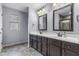 Bathroom featuring a double vanity with dark cabinets, framed mirrors, and tiled flooring at 952 Workington Cir, Westfield, IN 46074