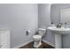Powder room with a pedestal sink, toilet, and light blue walls at 952 Workington Cir, Westfield, IN 46074
