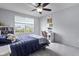 Bedroom featuring a large window with blinds, a ceiling fan, a bed, and a desk with a chair at 952 Workington Cir, Westfield, IN 46074