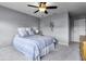 Bedroom features neutral walls, plush carpet, ceiling fan, and a comfortable bed at 952 Workington Cir, Westfield, IN 46074
