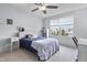 Bedroom featuring a large window with blinds, a ceiling fan, a bed, and a desk with a chair at 952 Workington Cir, Westfield, IN 46074