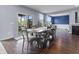 Dining area boasts a long wooden table with seating for eight, hardwood floors, and sliding glass doors at 952 Workington Cir, Westfield, IN 46074