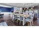 Open dining area with wood floors, a gray table with seating for six, and open access to the kitchen at 952 Workington Cir, Westfield, IN 46074