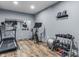Home exercise room equipped with treadmill, spin bike, free weights, and a mirror at 952 Workington Cir, Westfield, IN 46074