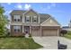 Charming two-story home featuring brick and siding, a well-manicured lawn, and an attached two-car garage at 952 Workington Cir, Westfield, IN 46074
