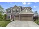 Charming two-story home featuring brick and siding, a well-manicured lawn, and an attached two-car garage at 952 Workington Cir, Westfield, IN 46074