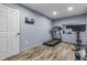 Home gym features wood-look floors, exercise equipment, and a white door at 952 Workington Cir, Westfield, IN 46074