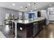 Kitchen featuring dark cabinetry and a large granite-topped island, flowing into the dining area for easy entertaining at 952 Workington Cir, Westfield, IN 46074