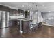 Bright kitchen featuring dark cabinets, stainless steel appliances, pendant lighting, and an eat-in island at 952 Workington Cir, Westfield, IN 46074