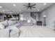 Open concept living room features a large sectional sofa, neutral walls, and an adjacent kitchen at 952 Workington Cir, Westfield, IN 46074
