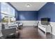 Stylish living room with blue walls, hardwood floors, and comfortable seating at 952 Workington Cir, Westfield, IN 46074