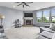 Bright living room with large windows, a brick fireplace, and a comfortable gray sofa at 952 Workington Cir, Westfield, IN 46074