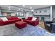 Finished basement living room features a grey rug and red couches at 952 Workington Cir, Westfield, IN 46074