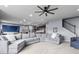 Cozy living area showcases a gray sectional, an adjacent dining room, and a staircase at 952 Workington Cir, Westfield, IN 46074