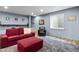 Finished basement living room features a grey rug and red couch at 952 Workington Cir, Westfield, IN 46074