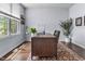 Bright office with a large window and a dark wooden desk resting on a decorative rug at 952 Workington Cir, Westfield, IN 46074