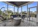 Screened-in porch with cozy seating and fire pit at 952 Workington Cir, Westfield, IN 46074