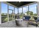 Screened-in porch with cozy seating and fire pit at 952 Workington Cir, Westfield, IN 46074