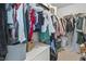 Walk-in closet with an array of clothing hanging from racks, featuring a built-in bench, offering ample storage at 952 Workington Cir, Westfield, IN 46074
