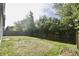 Green backyard featuring grass, a wooden fence, and tree coverage in the back at 9613 W Stargazer Dr, Pendleton, IN 46064
