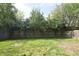 Spacious backyard with a wooden fence providing privacy and some mature trees in the back at 9613 W Stargazer Dr, Pendleton, IN 46064