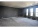 Main bedroom featuring carpeted floors and three windows with dark curtains at 9613 W Stargazer Dr, Pendleton, IN 46064