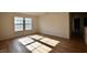 Sunlit bedroom featuring wood-look floors, neutral walls, and double windows at 9613 W Stargazer Dr, Pendleton, IN 46064