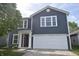 Charming two-story home with blue siding, white trim, and an attached two-car garage at 9613 W Stargazer Dr, Pendleton, IN 46064