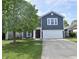 Inviting two-story home with a well-manicured lawn and a driveway leading to a two-car garage at 9613 W Stargazer Dr, Pendleton, IN 46064