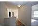 Bright hallway with wood-look flooring, neutral paint, and access to multiple rooms at 9613 W Stargazer Dr, Pendleton, IN 46064
