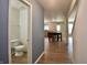 Hallway view featuring a half-bathroom and an open-concept dining and kitchen area at 9613 W Stargazer Dr, Pendleton, IN 46064