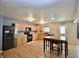 Open kitchen with stainless appliances, wood cabinets, and a dining table at 9613 W Stargazer Dr, Pendleton, IN 46064