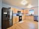 Modern kitchen with stainless steel appliances, wooden cabinets, and wood-look flooring at 9613 W Stargazer Dr, Pendleton, IN 46064