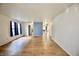Spacious living room featuring wood-look flooring, white walls, and ample natural light at 9613 W Stargazer Dr, Pendleton, IN 46064