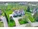 Expansive aerial view showcases the landscaped property and a large circular driveway at 9790 Summerlakes Dr, Carmel, IN 46032