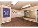Versatile finished basement with mirror wall and 'Music is Life' banner, perfect for a home studio at 9790 Summerlakes Dr, Carmel, IN 46032