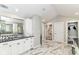 Spacious bathroom featuring marble floors, a marble shower, and white cabinets at 9790 Summerlakes Dr, Carmel, IN 46032