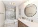 Tastefully updated bathroom with a marble tiled shower, quartz countertop and elegant bronze fixtures at 9790 Summerlakes Dr, Carmel, IN 46032