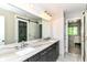 Bathroom with double sink vanity featuring a beautiful marble countertop and modern lighting at 9790 Summerlakes Dr, Carmel, IN 46032