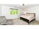 This bedroom features a comfortable bed, a chair, and a window that lets in natural light at 9790 Summerlakes Dr, Carmel, IN 46032