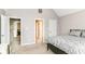 This bedroom is bright with a large window and views of the en suite bathroom entrance at 9790 Summerlakes Dr, Carmel, IN 46032
