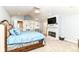 Bright bedroom featuring a fireplace with mantel, built-in shelving, and a blue comforter on the bed at 9790 Summerlakes Dr, Carmel, IN 46032