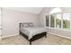 Bright bedroom with window and vaulted ceilings, featuring modern decor and cozy carpet at 9790 Summerlakes Dr, Carmel, IN 46032