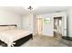 Relaxing bedroom features a closet and a view to the hallway with circle mirror accent at 9790 Summerlakes Dr, Carmel, IN 46032