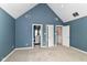 Bedroom with light-blue walls, a vaulted ceiling, and multiple doorways at 9790 Summerlakes Dr, Carmel, IN 46032