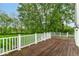 Wood deck with white railings, overlooking a lush green lawn and mature trees at 9790 Summerlakes Dr, Carmel, IN 46032