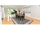 Bright dining room featuring hardwood floors, large windows, and a grand piano at 9790 Summerlakes Dr, Carmel, IN 46032