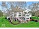 Back of large home featuring a deck, patio, and a beautifully landscaped lawn at 9790 Summerlakes Dr, Carmel, IN 46032