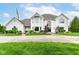 Stunning white brick home features a beautifully landscaped yard and a circular driveway at 9790 Summerlakes Dr, Carmel, IN 46032